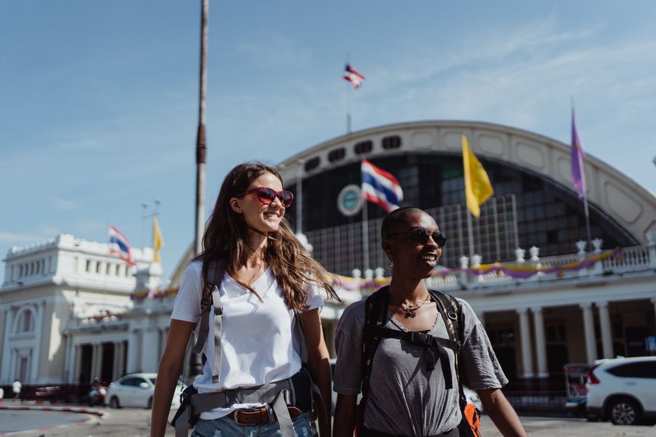 Two women enjoying a sunny day at Hua Lamphong train station, Bangkok.