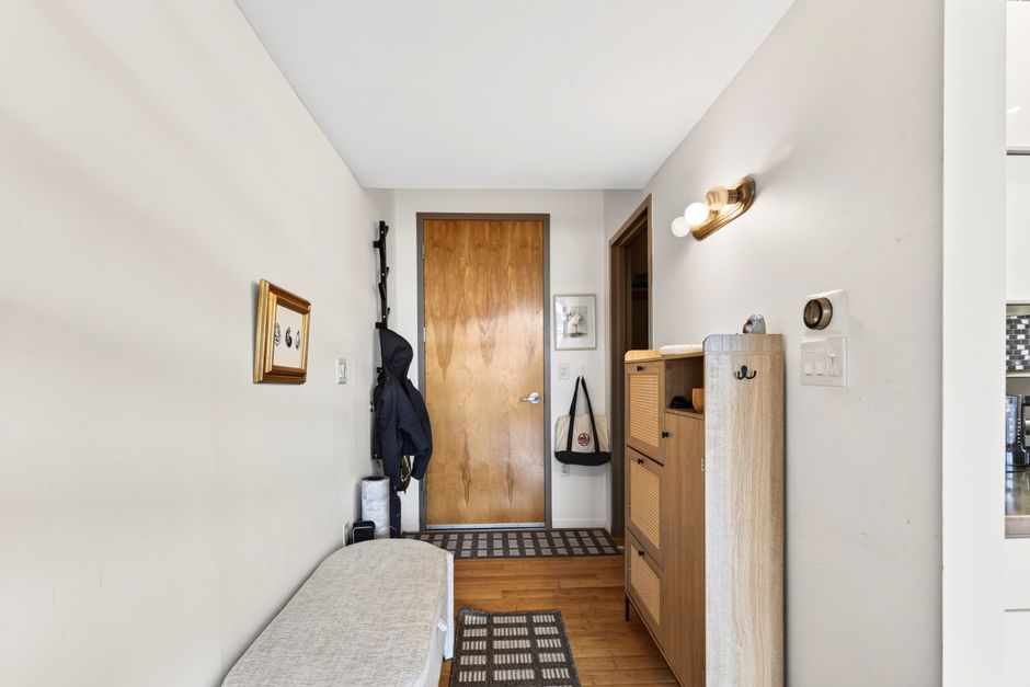 Contemporary entry hallway in Boston apartment showcasing modern industrial decor and wood