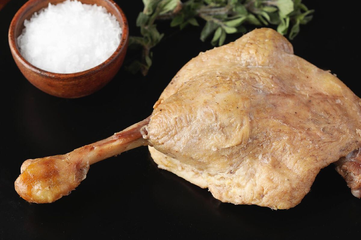 D'Artagnan duck leg confit in a dark pan