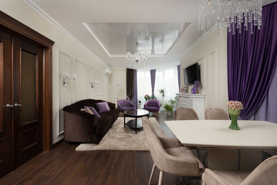 Stylish interior design in a modern living room featuring purple accents and luxurious furnishings.