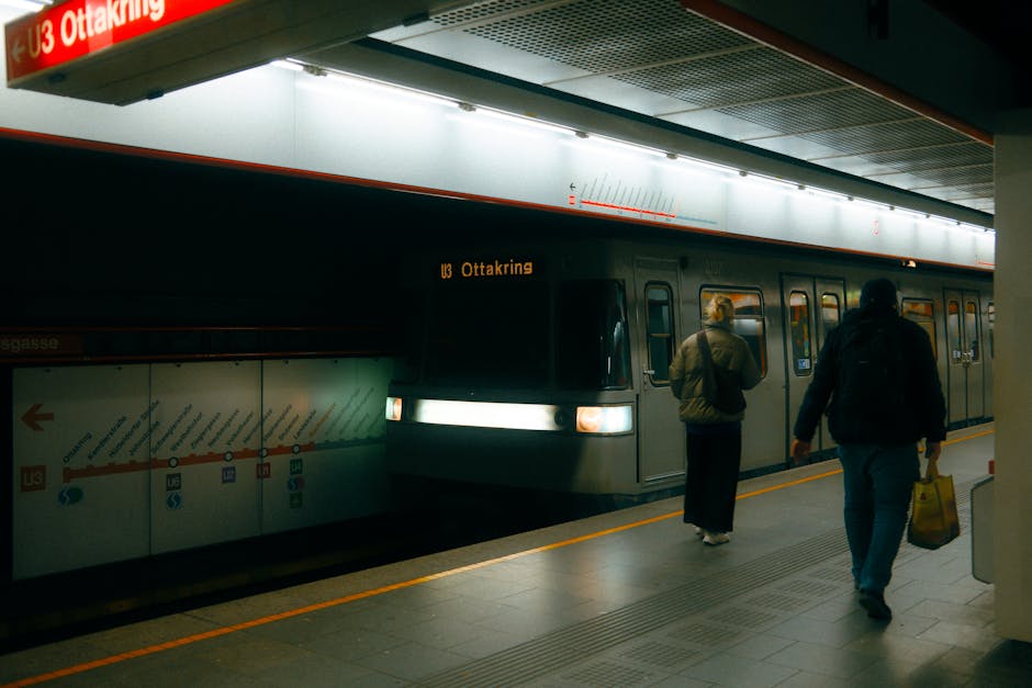 View of Vienna U3 Ottakring metro station with train and commuters during daytime.