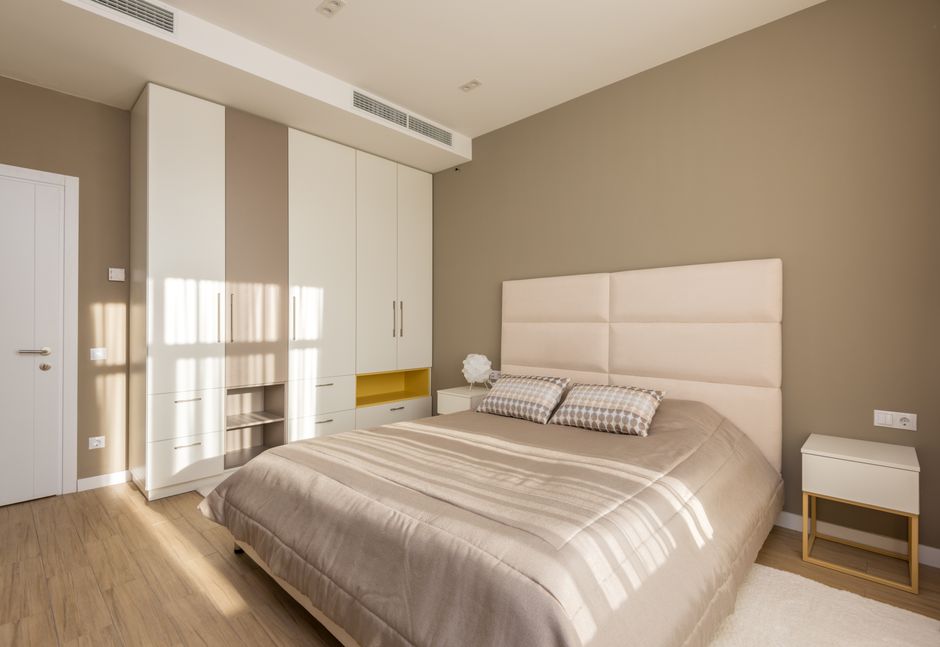 Stylish modern bedroom featuring minimalist design with elegant furniture and soft neutral