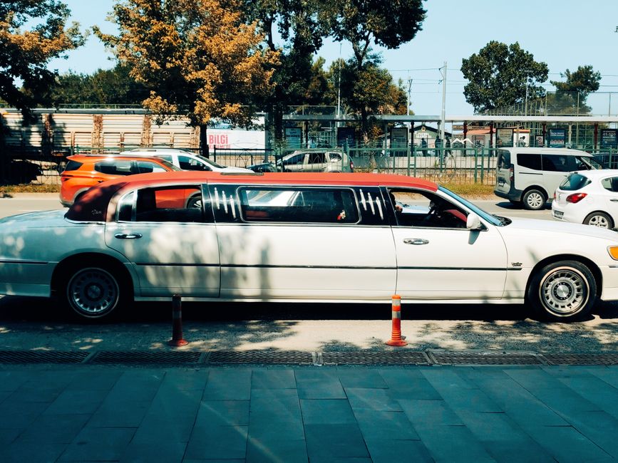 Long white limousine parked on a sunny street in Samsun, Türkiye.