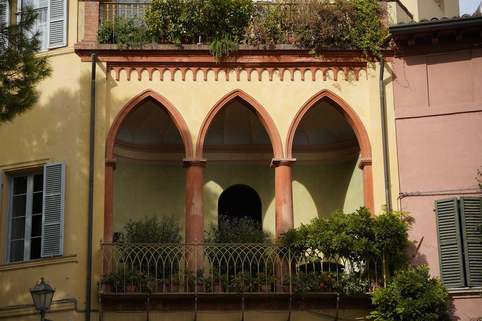 Picturesque balcony with arches in Santarcangelo di Romagna, showcasing classic Italian architecture.